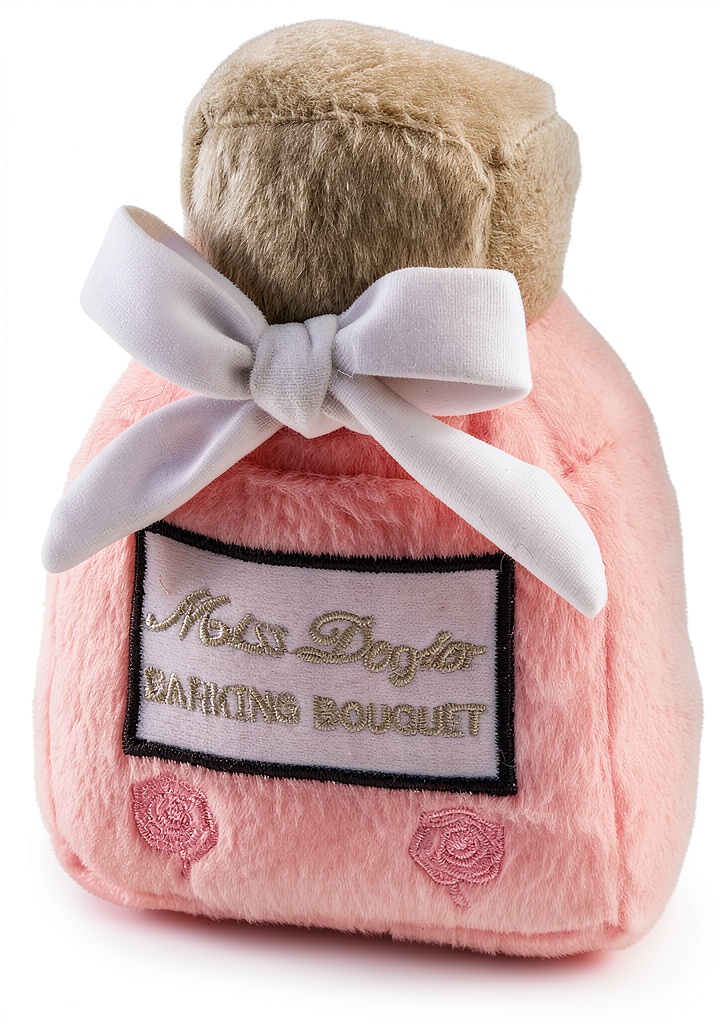 Miss Dogior Perfume Bottle plush dog toy on a grassy background